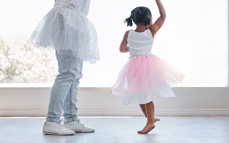 Children dancing in tutus, practicing ballet.