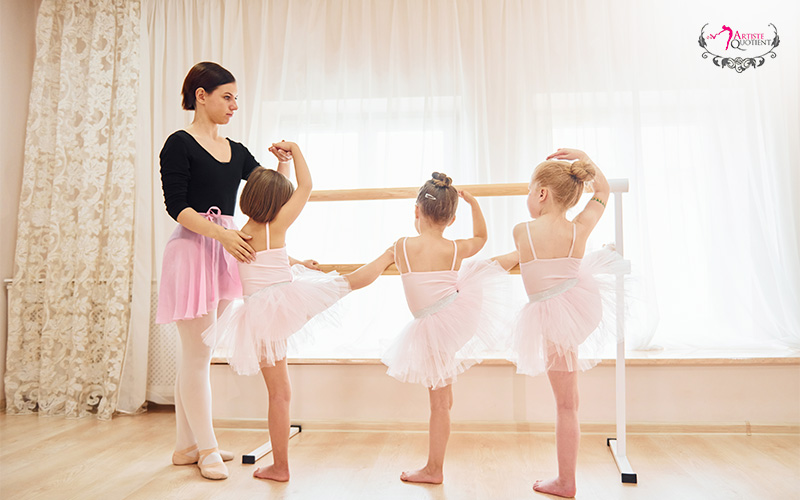 AQ Dance instructor teaching young students ballet at the barre.
