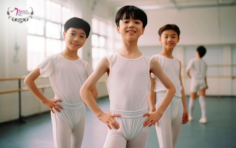 Happy boys in white ballet attire in class.