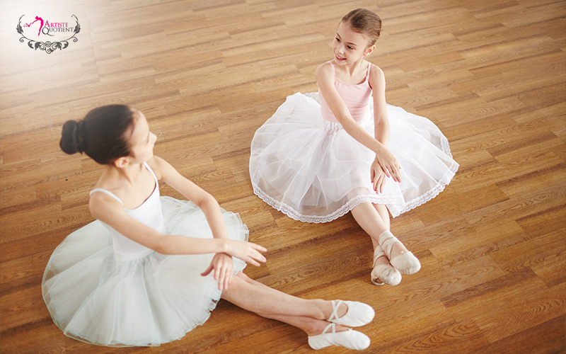 Young ballet dancers building friendships in studio.