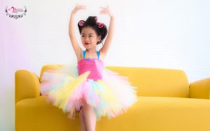 Young girl in ballet tutu practicing at home.